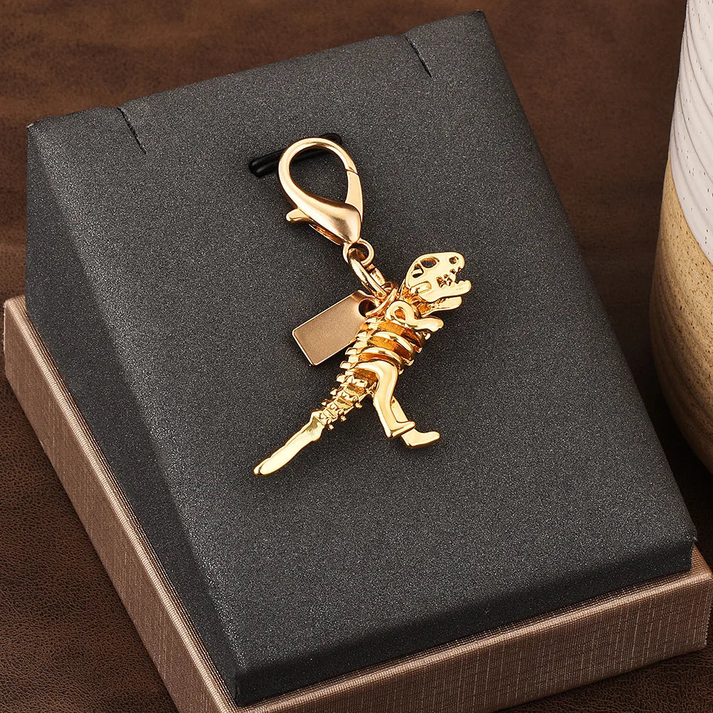 Mini Charm „Dino“ – Eleganter Schlüsselanhänger in Goldoptik
